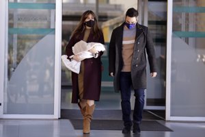 Isabel Jiménez y Álex Cruz, con su hijo Dani abandonando el Hospital Quirónsalud Madrid