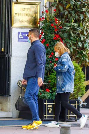 La pareja, entrando en un lujoso hotel de la capital