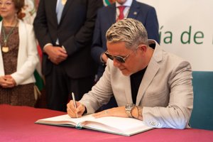 El artista firmando en el libro de honor de la Diputación
