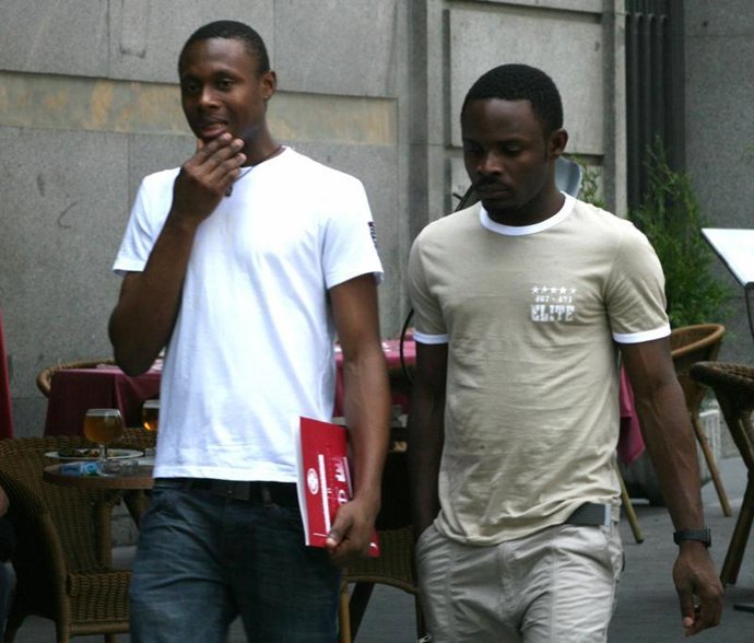 Dos inmigrantes caminan por la calle - recursos