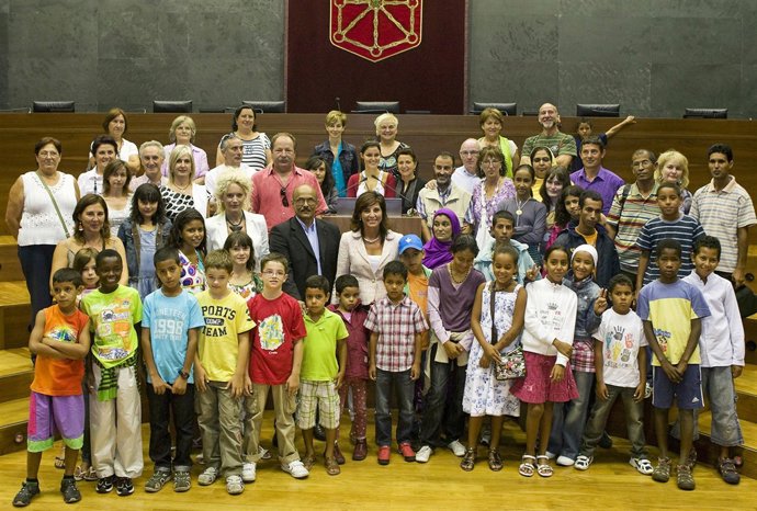 Los niños saharauis posan en el Parlamento de Navarra junto a la presidenta Torr