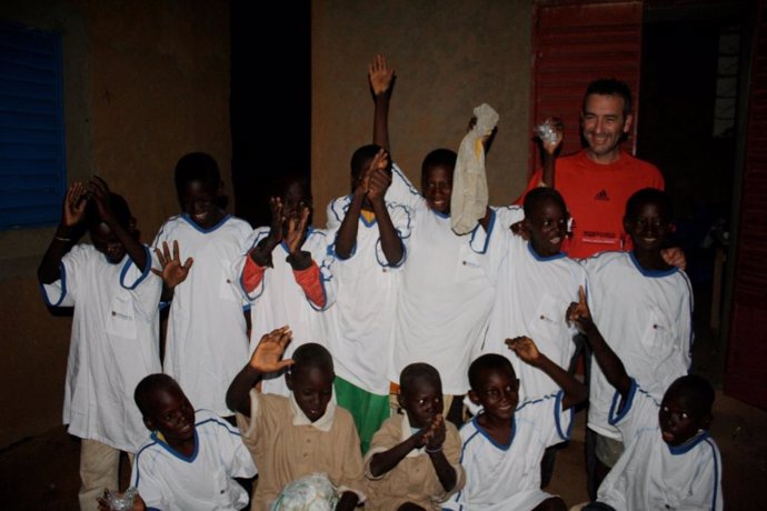 Un voluntario de Caja España con niños de Mali
