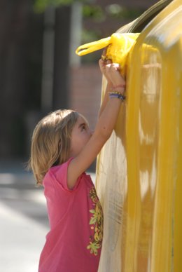 Niña Reciclando En Un Contenedor De Plástico