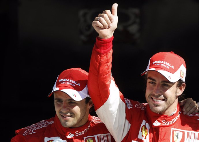 Ferrari Formula One driver Fernando Alonso (R) of Spain celebrates with his team