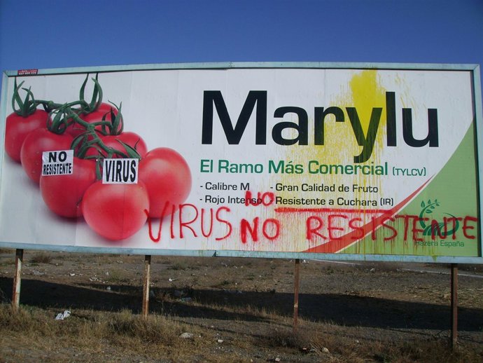 Cartel publicitario con pintadas de agricultores afectados.