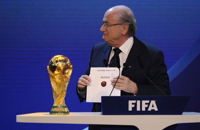 FIFA President Sepp Blatter holds up the name of Russia during the official anno