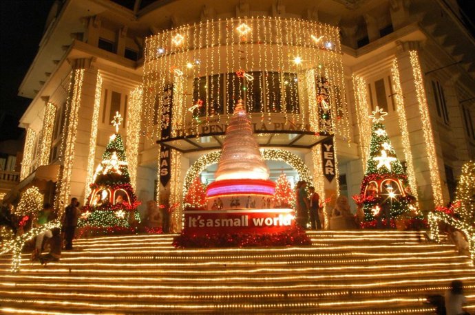 Fachada del Peninsula Plaza en Bangkok decorada con luces y estrellas navideñas.