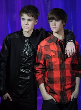 Canadian popstar Justin Bieber (L) poses with his waxwork model as it is unveile