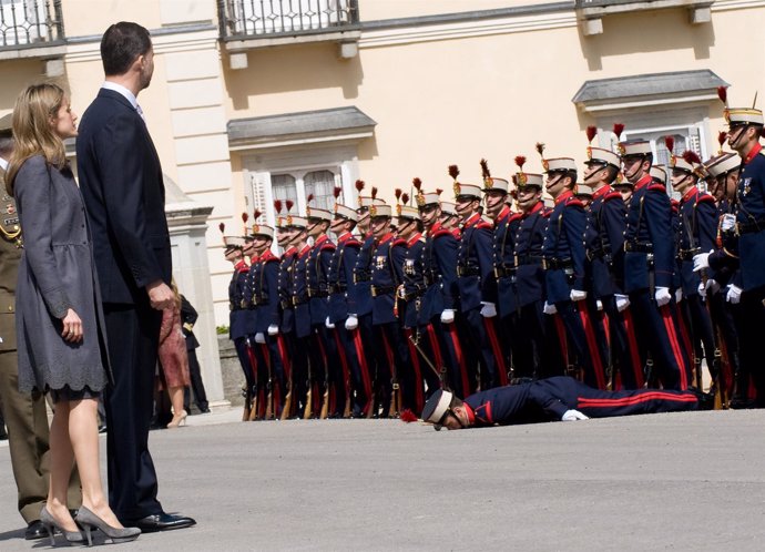Prince Felipe and Princess Letizia of Spain look on after a guard collapsed at t