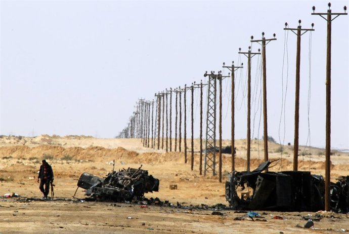 Libia. A Rebel Fighter Walks At The Front-Line