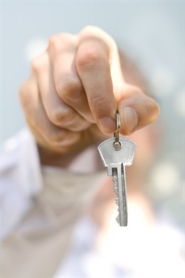 Hand Holds A Key (Key In Focus)