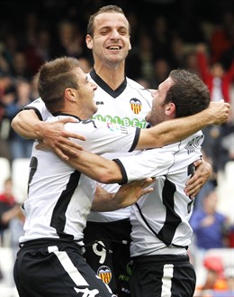 Valencia's Soldado Celebrates With Team Mates Joaquin And Mata After He Scored A