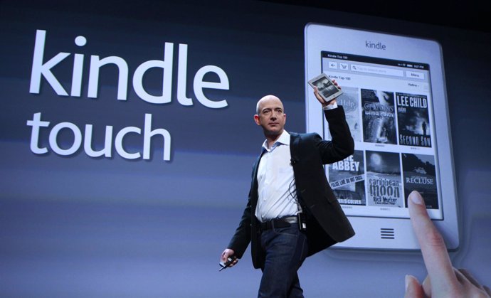 Amazon CEO Bezos Holds Up The New Kindle Touch At News Conference In New York