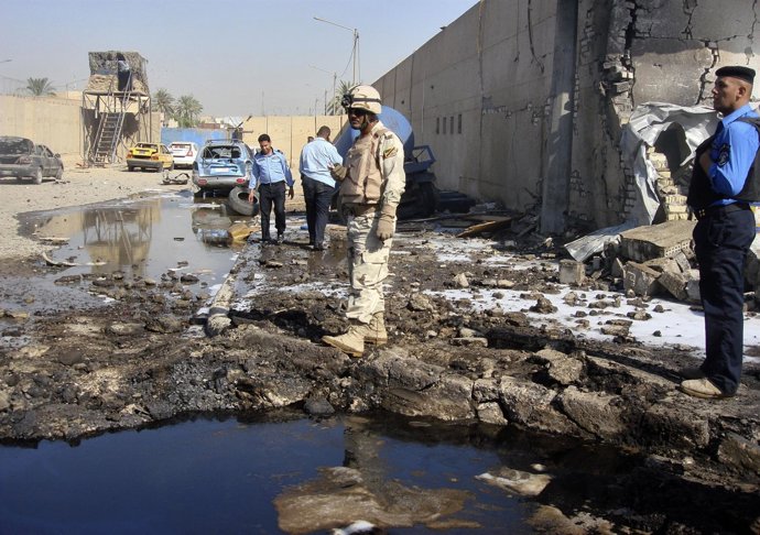 A Soldier And Policemen Inspect The Site Of A Bomb Attack At A Police Station In