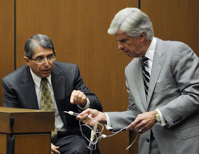 Defense Attorney J. Michael Flanagan And Defense Witness Dr. Paul White Look At 