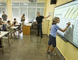 Un Alumno Escribe En Una Pizarra En Clase.