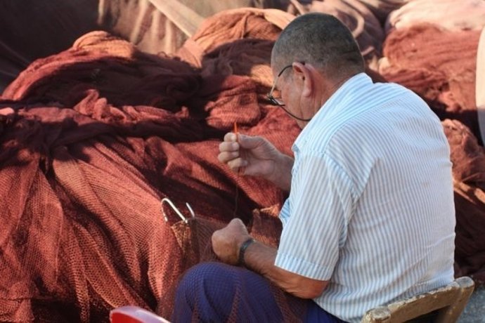 Un Pescador Trabaja Con Una Red De Pesca.