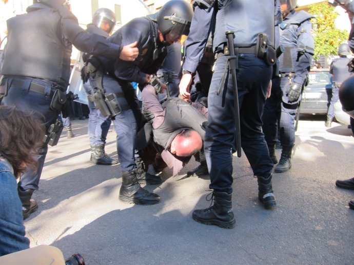 Agentes De Policía Con Uno De Los Detenidos