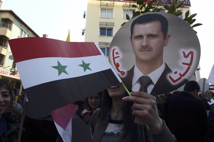 Recurso De Una Manifestación Siria Con La Bandera Y La Cara De Al Assad