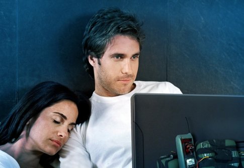 Man Using Laptop In Bed