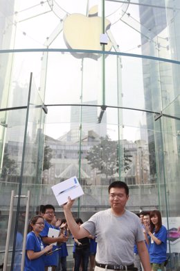 A customer displays his new iPad during its China launch at the Shanghai Apple