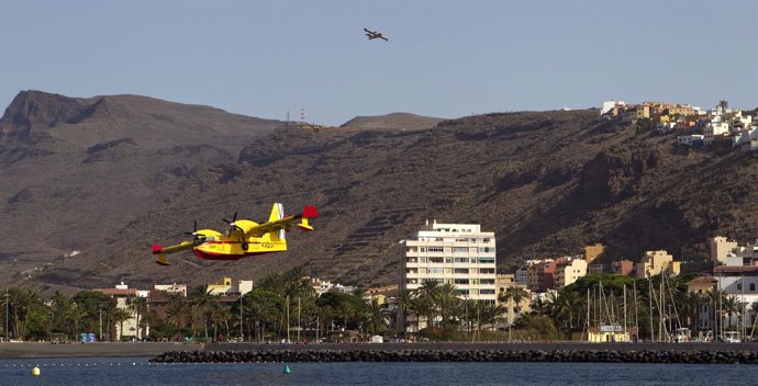 Firefighting planes prepare to take in water at San Sebastian de la Gomera on th