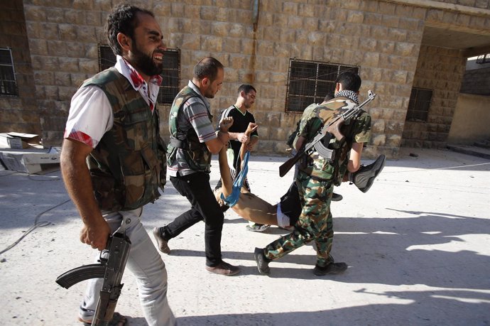 Rebeldes sirios trasladan el cuerpo sin vida de un compañero