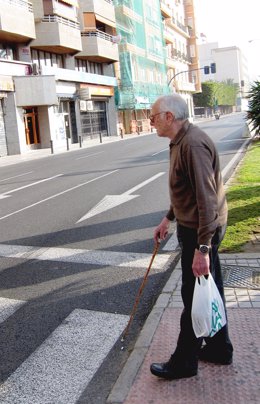 Una Persona Mayor Cruza Por Una Calle De Alicante
