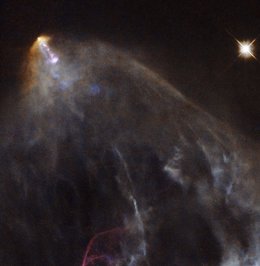 This image shows an object known as HH 151, a bright jet of glowing material tra