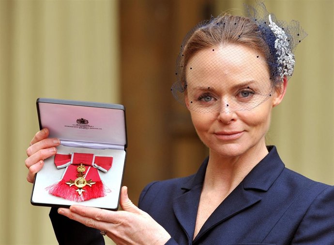 Fashion designer Stella McCartney holds her Officer of the British Empire (OBE) 