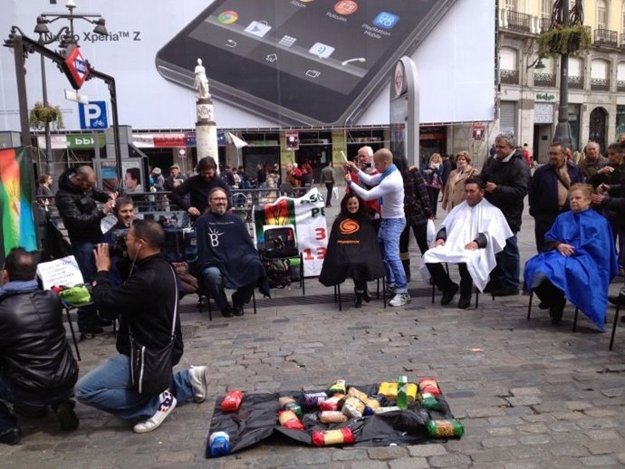 Peluqueros de Sevilla realizan un 'corte de pelo solidario' en la Puerta del Sol