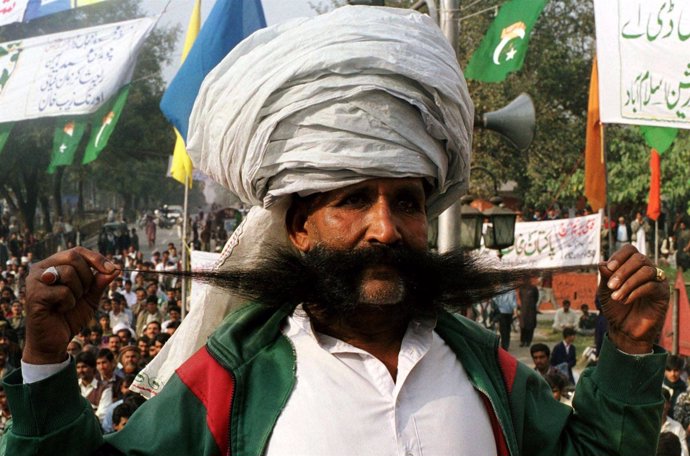 Ellahi Bakhsh Baluch, a Pakistani renowned for his thick mustache, poses on a st