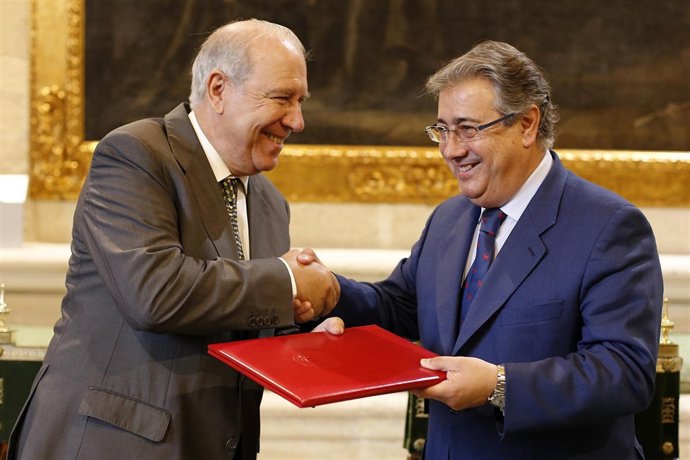 Zoido firmando con el presidente del Banco de Alimentos.