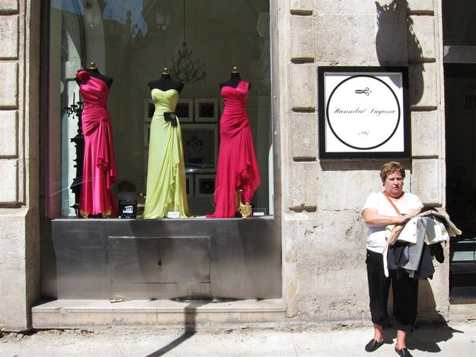 La excosturera a su salida de la tienda, tras retirar los trajes embargados