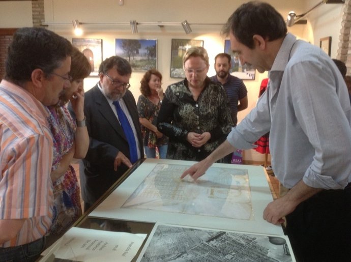 Cifuentes y Martínez observan un mapa en la muestra sobre Mancha Real.