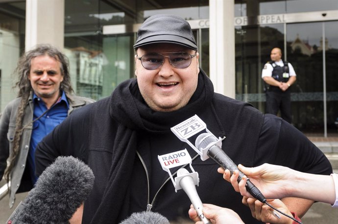 Megaupload founder Dotcom talks to members of the media outside the New Zealand 