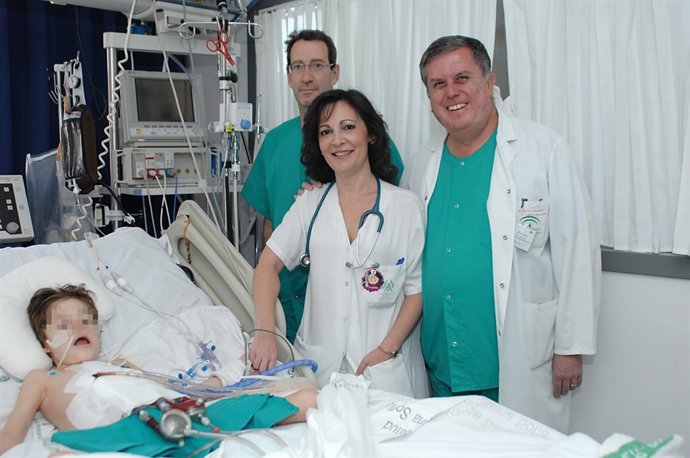 Los doctores visitan al niño ingreso en la UCI pediatrica