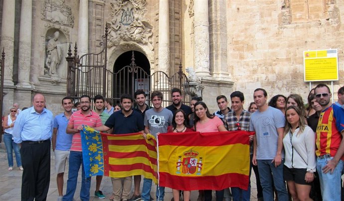 Caravana de NNGG ante el Miguelete con la bandera de España y la Reial Senyera 