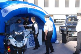 Ignacio Cosidó visita el stand informativo de la Policía en la Vuelta Ciclista