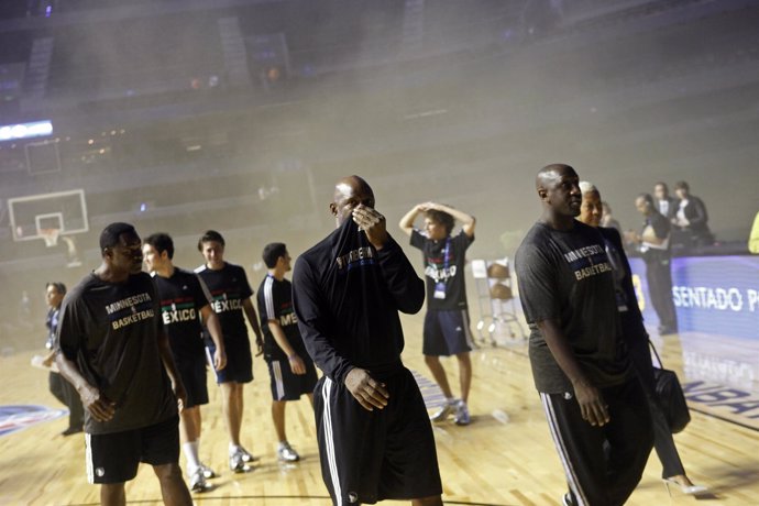 Minnesota Timberwolves players walk off the court amidst smoke after a transform