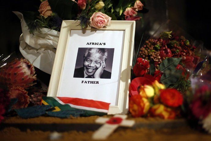 Flowers and tributes are left on the Nelson Mandela statue on Parliament Square 