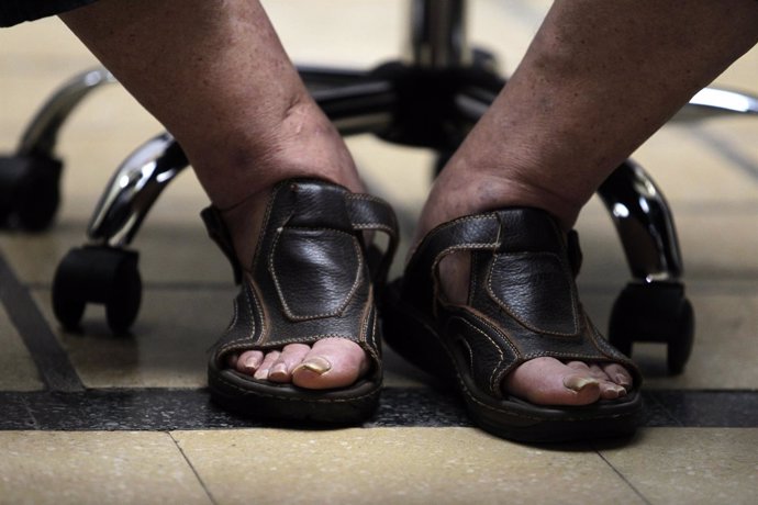 Sandals of Uruguay's President Jose Mujica seen as he participates in signing in