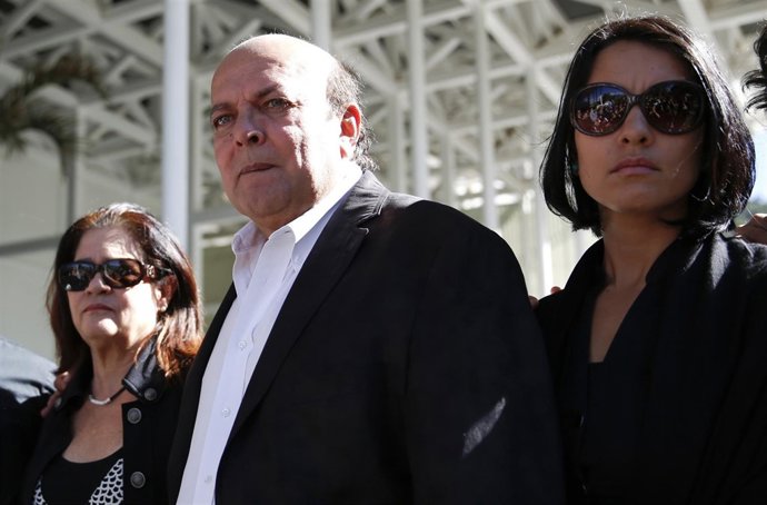 Spear and Mootz, parents of former Miss Venezuela Monica Spear, stand next to th