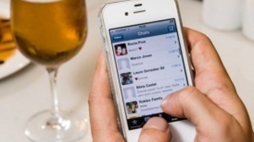 Teléfono móvil smartphone iPhone en un bar cafetería cerveza tapa