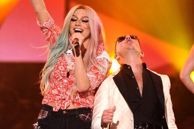 LOS ANGELES, CA - NOVEMBER 24:  Singer Keha (L) and rapper Pitbull perform onsta