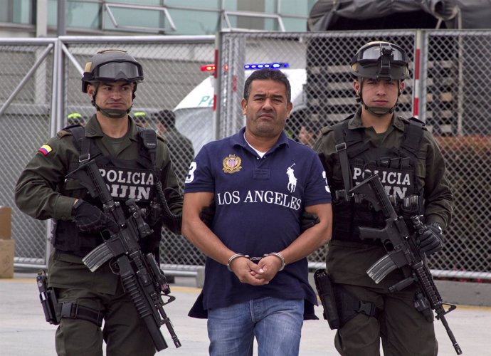 Colombian alleged drug trafficker Diego Perez Henao is escorted by policemen bef
