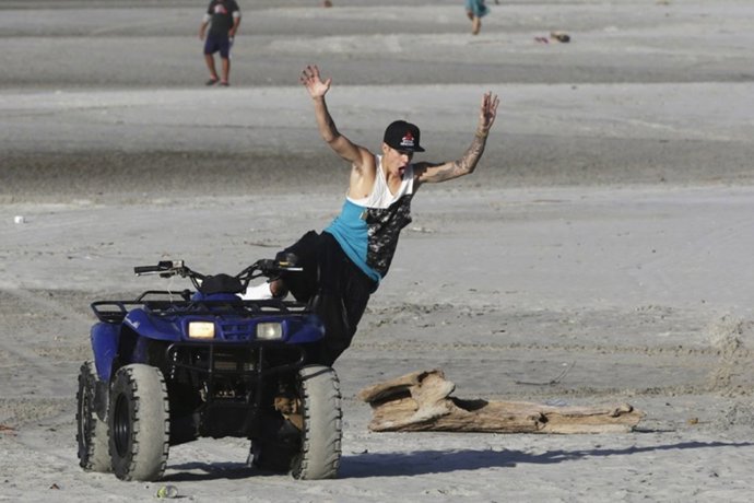 Canadian singer Justin Bieber jumps from a quad bike at a resort in Punta Chame,