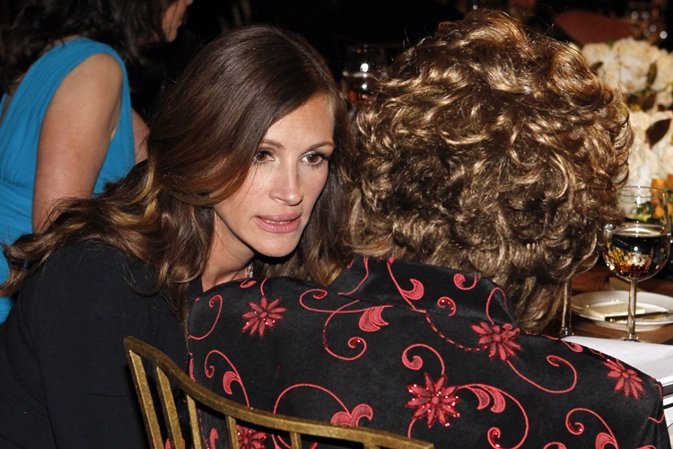 Actress Julia Roberts (L) talks with actress Shirley MacLaine as they sit at the