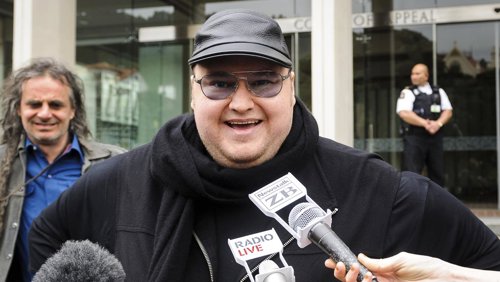 Megaupload founder Dotcom talks to members of the media outside the New Zealand 