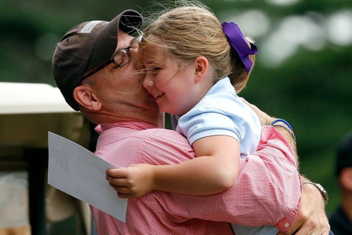 PLYMOUTH, MA - AUGUST 12:  A participant gets a hug from her dad after she parti